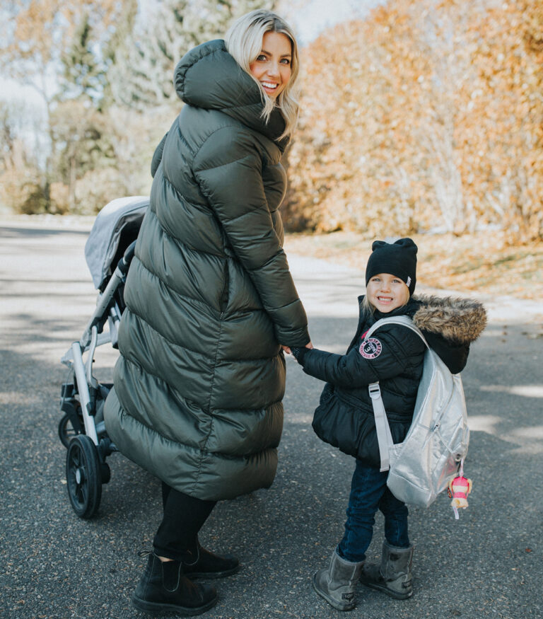 A lady and a baby walking on the road
